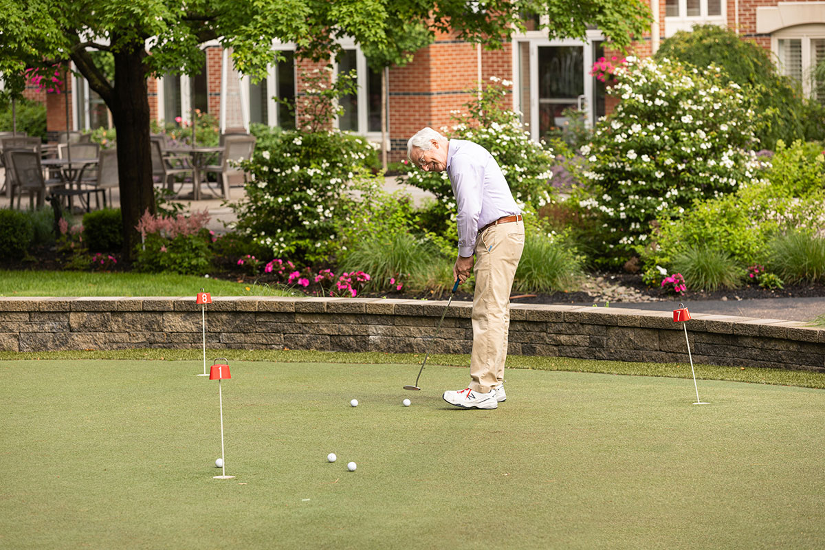 A man putting a golf ball