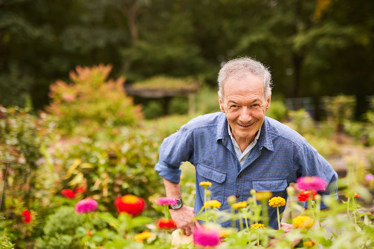 A man smiling standing in the garden