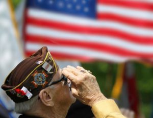 A veteran saluting the American flag
