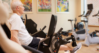 Man exercising on spin bike.